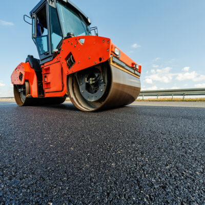 Asphalt road making construction site with heavy machines